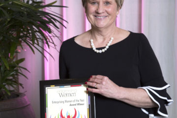 image of Mary Kruse, HealthSource Solutions President & CEO holding the Enterprising Women of the year award