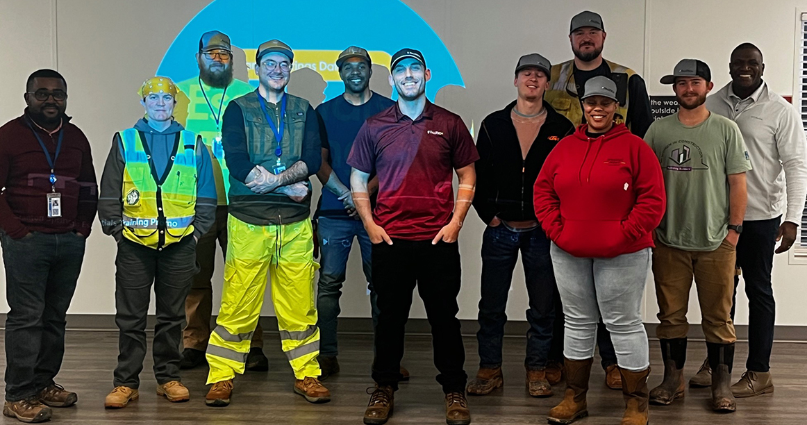 Group of construction employees smiling after training