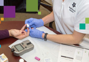 HSS employee giving finger stick test