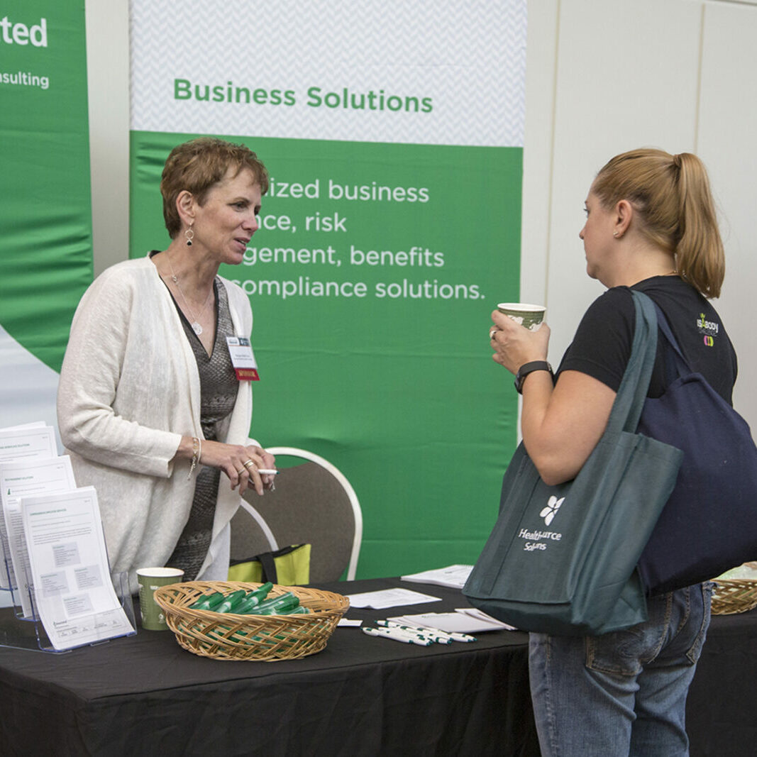 Conference attendees at exhibit booths