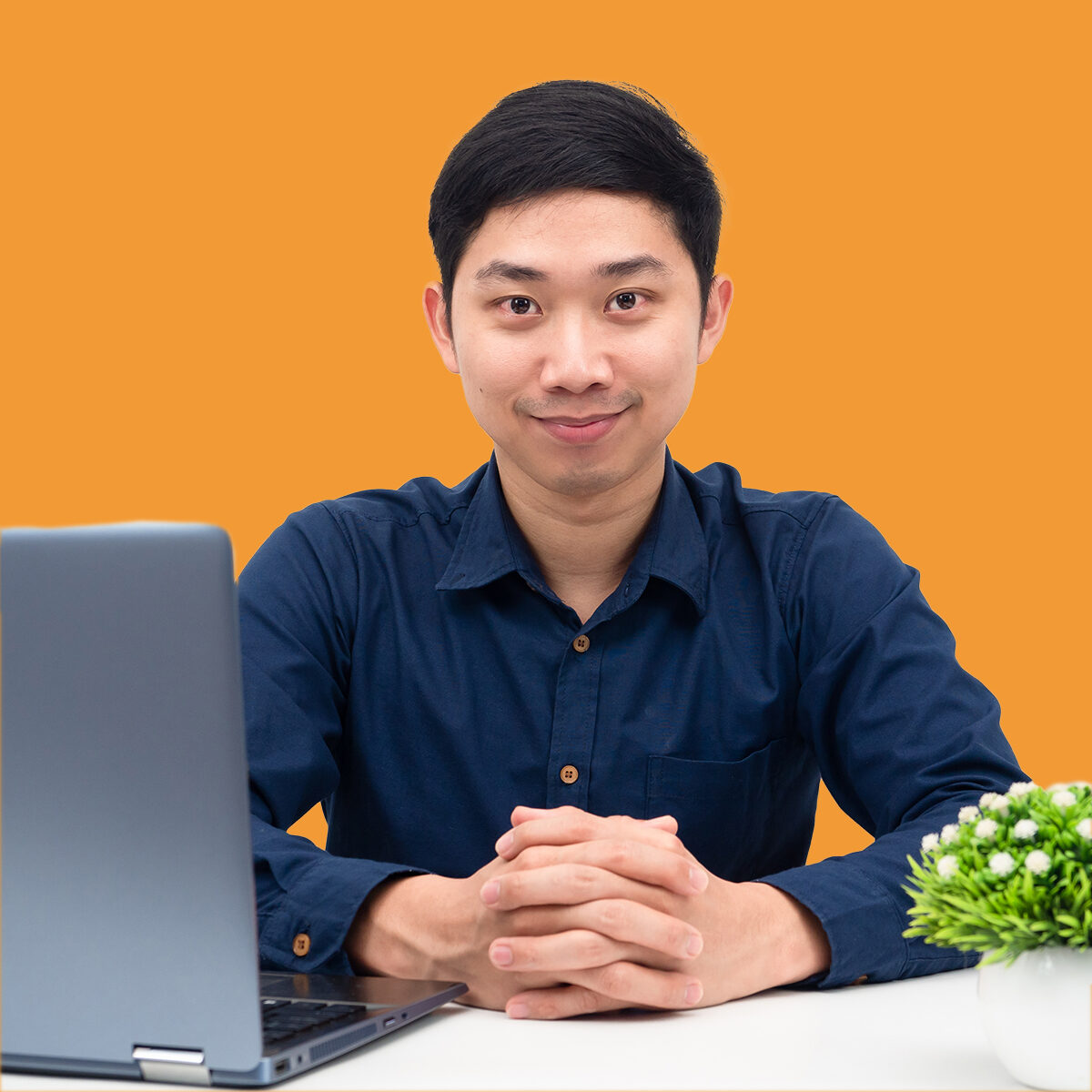 Young Asian man looking confident sitting at the table with laptop workplace