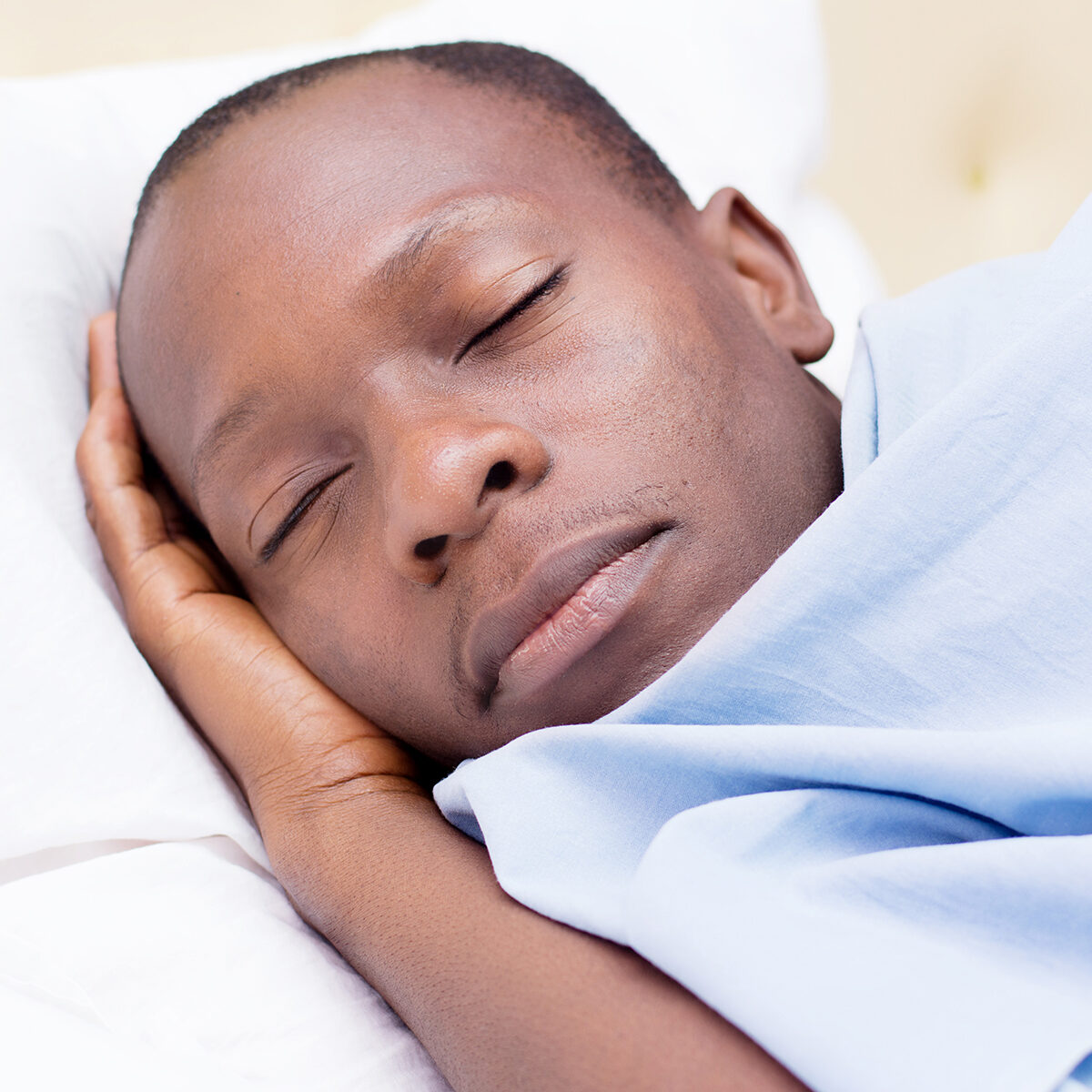 this young man asleep and enjoying the comfort of the bed