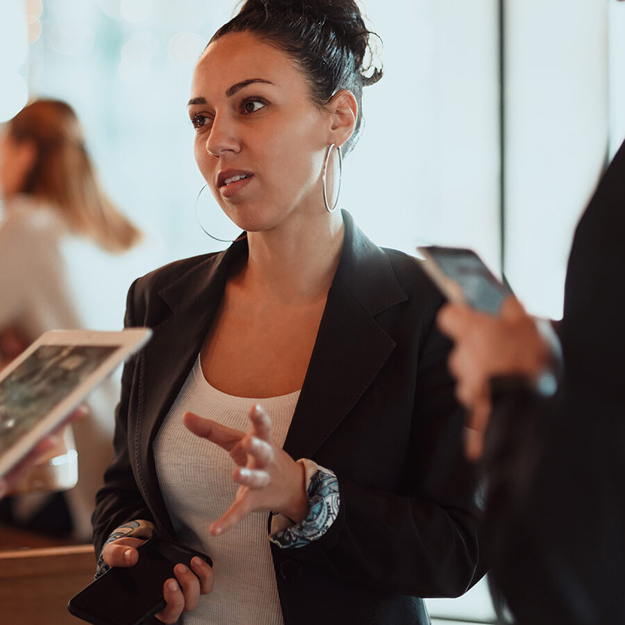 a group of young entrepreneurs on a coffee break discuss the project while using modern editing tablets, a smartphone and a laptop
