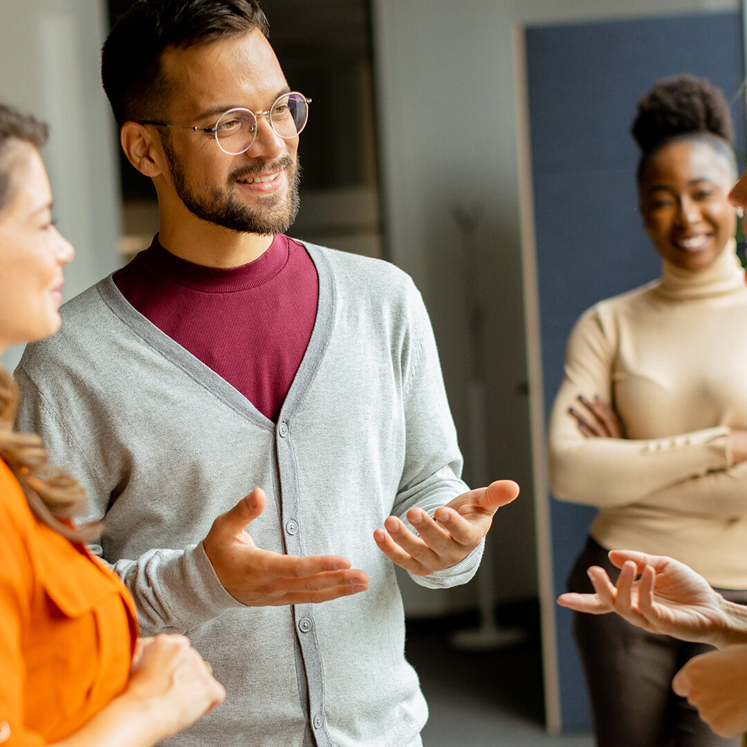 work team of four people conversing