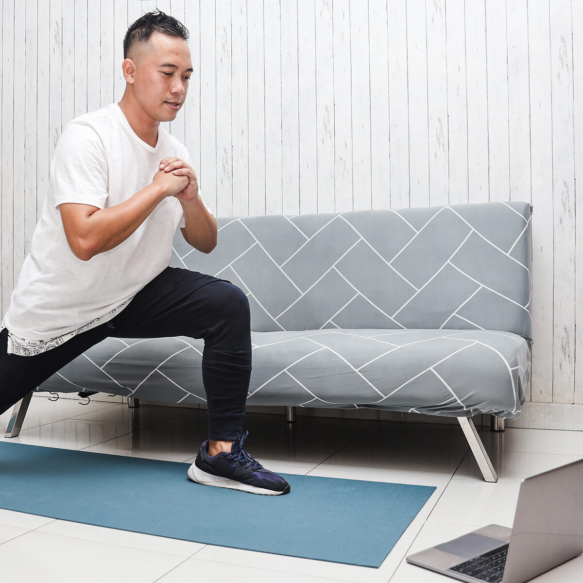 a guy doing lunges in a corporate fitness center
