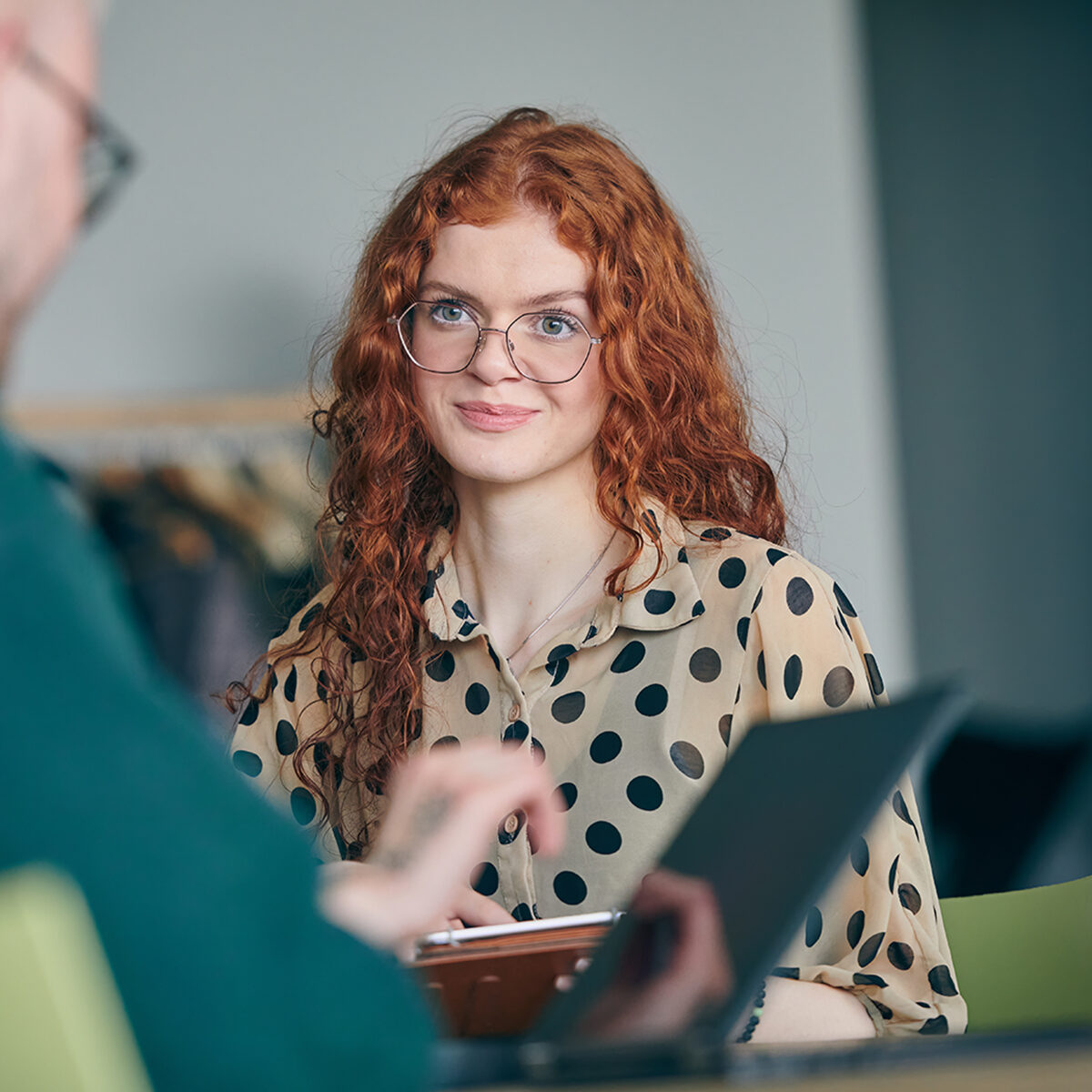 Young red-haired student intern in meeting